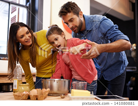 Parents, girl and kitchen for baking with love, ingredients for cake or dessert with support and handmade with care. Mom, dad and kid with wow face for mixture with bonding or teaching with affection Parents, girl and kitchen for baking with love, ingredients for cake or dessert with support and handmade with care. Mom, dad and kid with wow face for mixture with bonding or teaching with affection 141080881