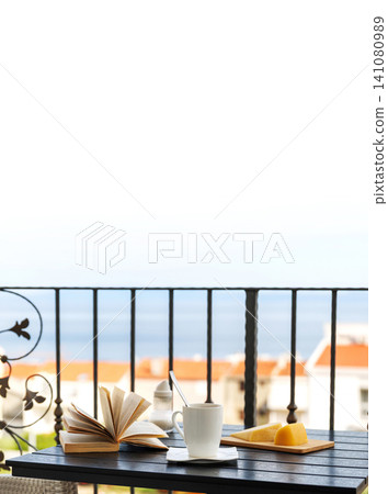 Balcony breakfast with coffee and open book with Adriatic sea view and large copy space Balcony breakfast with coffee and open book with Adriatic sea view and large copy space 141080989