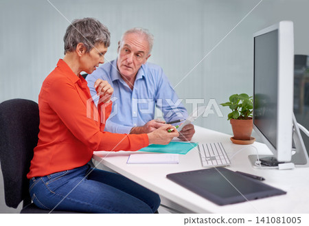 Paperwork, discussion and senior woman with financial advisor in planning for pension fund in office. Conversation, documents and elderly female person with finance consultant for retirement savings. Paperwork, discussion and senior woman with financial advisor in planning for pension fund in office. Conversation, documents and elderly female person with finance consultant for retirement savings. 141081005
