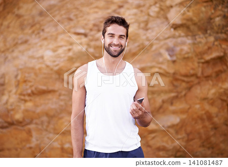 Fitness, earphones and portrait of man with phone for exercise, workout and music for training. Male person, headphones and face with happiness for online streaming, podcast and morning cardio Fitness, earphones and portrait of man with phone for exercise, workout and music for training. Male person, headphones and face with happiness for online streaming, podcast and morning cardio 141081487