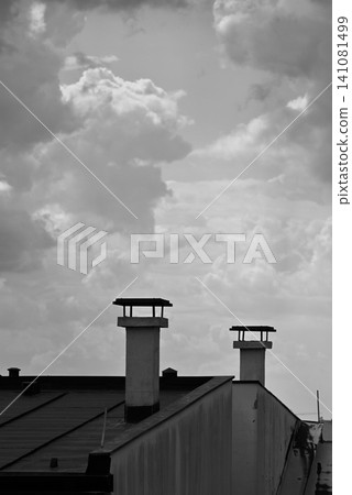 Black and white rooftop chimneys under cloudy sky Black and white rooftop chimneys under cloudy sky 141081499