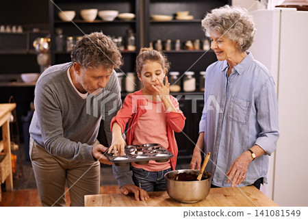 Girl, grandparents and baking with cupcakes, kitchen and bonding together. Mature couple, smile and child with happiness, love and learning at home with grandmother for childhood memories and family Girl, grandparents and baking with cupcakes, kitchen and bonding together. Mature couple, smile and child with happiness, love and learning at home with grandmother for childhood memories and family 141081549