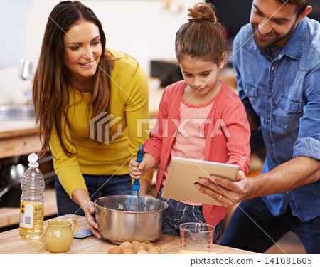 Family, kitchen and baking with tablet for recipe online with ingredients for cake or dessert with support and handmade. Mom, dad and girl child cooking together with love for bonding or teaching. Family, kitchen and baking with tablet for recipe online with ingredients for cake or dessert with support and handmade. Mom, dad and girl child cooking together with love for bonding or teaching. 141081605