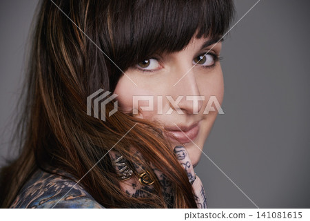 Happy woman, portrait and beauty with tattoo for haircare, style or facial treatment on a gray studio background. Face of female person or young model with smile for body art, design or creativity Happy woman, portrait and beauty with tattoo for haircare, style or facial treatment on a gray studio background. Face of female person or young model with smile for body art, design or creativity 141081615