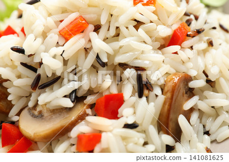 Delicious rice pilaf with bell peppers and mushrooms as background, closeup Delicious rice pilaf with bell peppers and mushrooms as background, closeup 141081625