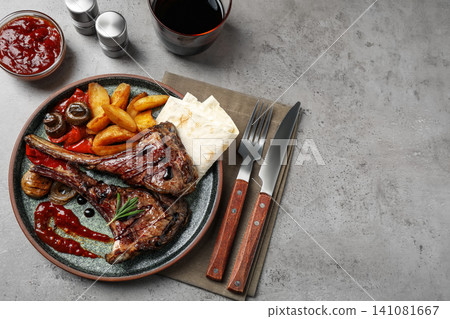 Delicious grilled ribs served on light grey table, flat lay. Space for text Delicious grilled ribs served on light grey table, flat lay. Space for text 141081667
