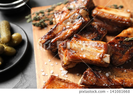 Delicious grilled ribs served on table, closeup 141081668