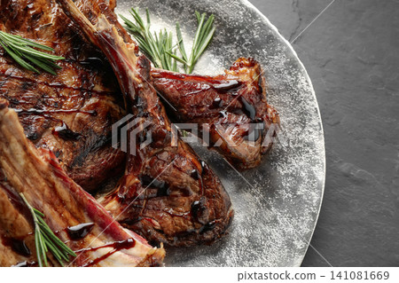 Delicious grilled ribs on black table, closeup Delicious grilled ribs on black table, closeup 141081669