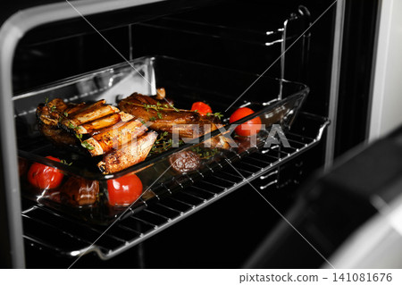 Delicious roasted ribs in oven. Yummy meat Delicious roasted ribs in oven. Yummy meat 141081676