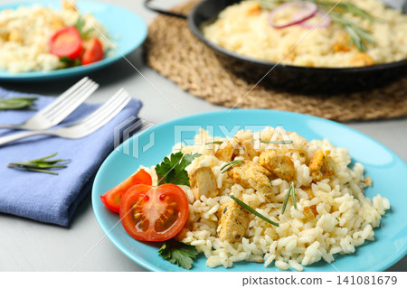 Delicious chicken risotto served on grey table Delicious chicken risotto served on grey table 141081679