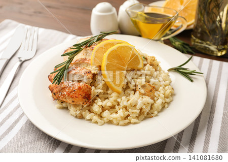 Delicious chicken risotto with lemon slices on table Delicious chicken risotto with lemon slices on table 141081680