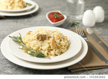 Delicious chicken risotto served on grey table Delicious chicken risotto served on grey table 141081682