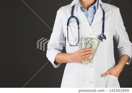 Doctor with bribe on black background, closeup. Corruption in medicine Doctor with bribe on black background, closeup. Corruption in medicine 141081699
