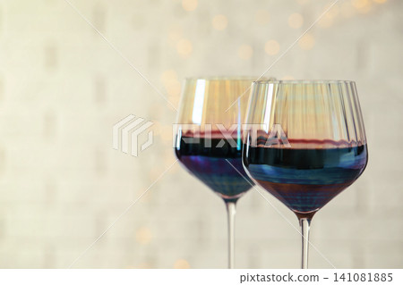 Glasses of red wine on light background, closeup. Space for text 141081885