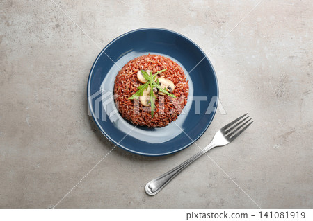 Delicious brown rice served on light table, flat lay Delicious brown rice served on light table, flat lay 141081919