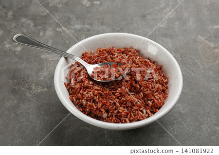 Tasty brown rice in bowl on grey table Tasty brown rice in bowl on grey table 141081922