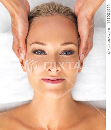 Closeup, portrait or woman in massage, therapy or mental health as self care, relax or luxury zen. Retreat, girl or hand in spa, head or chakra as peace, clinic or balance on resort cosmetology bed 141081933