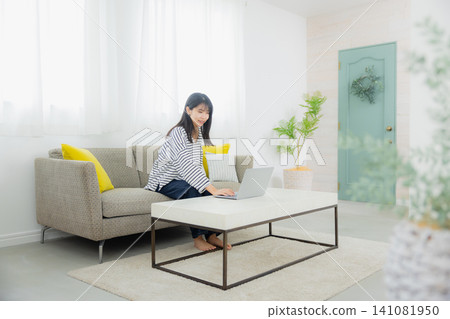 A young lady who operates a personal computer A young lady who operates a personal computer 141081950
