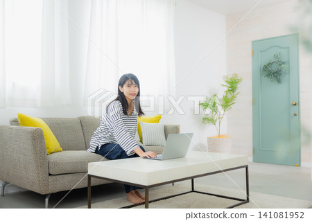 A young lady who operates a personal computer A young lady who operates a personal computer 141081952