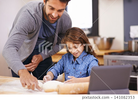 Pizza, dough and father with child in kitchen and tablet with recipe, guide and learning from online tutorial. Cooking, together and girl help with rolling pin and baking with dad in home for dinner Pizza, dough and father with child in kitchen and tablet with recipe, guide and learning from online tutorial. Cooking, together and girl help with rolling pin and baking with dad in home for dinner 141082353