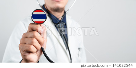 Thailand healthcare system, Thai national healthcare concept. Hand of doctor holding stethoscope Thailand healthcare system, Thai national healthcare concept. Hand of doctor holding stethoscope 141082544
