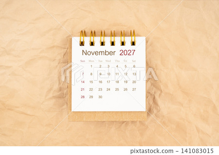 November 2027 mini desk calendar on old paper. November 2027 mini desk calendar on old paper. 141083015