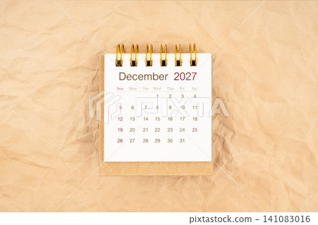 December 2027 mini desk calendar on old paper. December 2027 mini desk calendar on old paper. 141083016