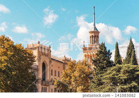 October 2024. Tbilisi, Georgia. Close-up of a historic stone tower with an ornate spire and arched windows among autumn leaves. Horizontal October 2024. Tbilisi, Georgia. Close-up of a historic stone tower with an ornate spire and arched windows among autumn leaves. Horizontal 141083082