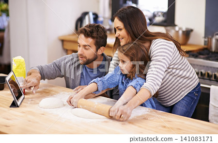Family, learning and cooking in kitchen with tablet for recipe, guide and parents with child in home. Baking, mom and dad helping girl with rolling pin and talking about pizza, dinner or meal prep Family, learning and cooking in kitchen with tablet for recipe, guide and parents with child in home. Baking, mom and dad helping girl with rolling pin and talking about pizza, dinner or meal prep 141083171