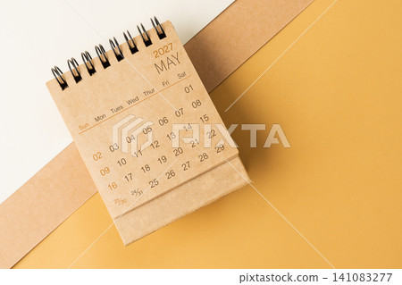 Blank desk calendar for May 2027 on brown tone background. Blank desk calendar for May 2027 on brown tone background. 141083277