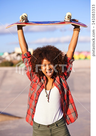 Portrait, fashion and excited black woman with skateboard in city for exercise, training and skating in skatepark. Skater, shouting and face of female person for trendy, edgy and hipster clothing 141083333