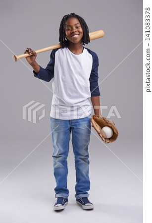 Baseball, portrait and black child in a studio with smile, sport and fitness gear with game of kid. Youth, happy and African boy with modern, casual and hipster fashion with glove and grey background Baseball, portrait and black child in a studio with smile, sport and fitness gear with game of kid. Youth, happy and African boy with modern, casual and hipster fashion with glove and grey background 141083378