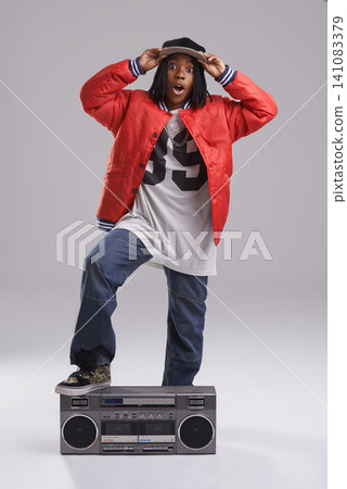 Child, hip hop and wow portrait with radio for music and rap in a studio with urban clothing. Fashion, African kid and boombox with trendy clothes and youth swag with confidence and grey background Child, hip hop and wow portrait with radio for music and rap in a studio with urban clothing. Fashion, African kid and boombox with trendy clothes and youth swag with confidence and grey background 141083379