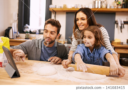Family, cooking and learning in kitchen with tablet for recipe, guide and parents with child in home. Baking, mom and dad helping girl with rolling pin and reading about pizza, dinner or meal prep Family, cooking and learning in kitchen with tablet for recipe, guide and parents with child in home. Baking, mom and dad helping girl with rolling pin and reading about pizza, dinner or meal prep 141083415