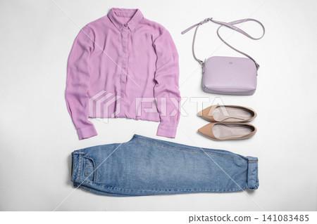 Stylish outfit with jeans on white background, top view Stylish outfit with jeans on white background, top view 141083485