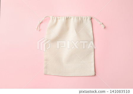 Cotton eco bag on pink background, top view Cotton eco bag on pink background, top view 141083510