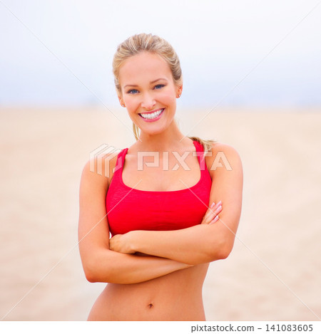 Woman, portrait and exercise on the beach with arms crossed, confidence and smile with wellness and outdoor. Fitness, athlete and sports with happiness for health, marathon or race for cardio workout 141083605