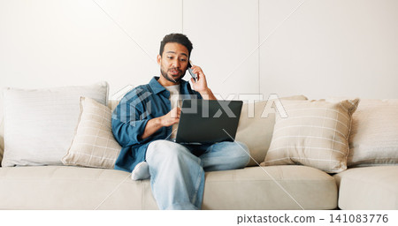 Phone call, laptop and man on sofa for remote work, contact and planning with communication. Freelance, home and person on tech for connection, project update and talking with feedback for report 141083776
