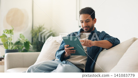 Streaming, digital or man on sofa with tablet, video subscription or post update on online site. Smile, browse or person in house with tech, internet search or show binge on entertainment platform. Streaming, digital or man on sofa with tablet, video subscription or post update on online site. Smile, browse or person in house with tech, internet search or show binge on entertainment platform. 141083779