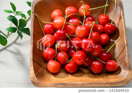 Fresh red cherries served on a wooden plate Fresh red cherries served on a wooden plate 141084010