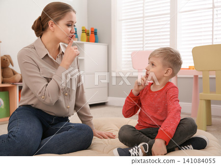 Speech therapist working with little boy in office Speech therapist working with little boy in office 141084055