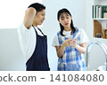 Kitchen: Image of a man and woman thinking up recipes on their smartphones. 141084080