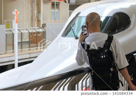 Tourists taking photos of the Shinkansen bullet train; the Shinkansen is popular with inbound tourists. Tourists taking photos of the Shinkansen bullet train; the Shinkansen is popular with inbound tourists. 141084334