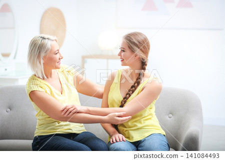 Mother and her adult daughter spending time together at home Mother and her adult daughter spending time together at home 141084493