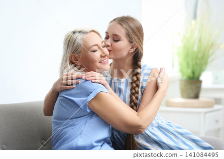 Mother and her adult daughter spending time together at home Mother and her adult daughter spending time together at home 141084495
