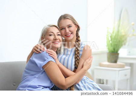 Mother and her adult daughter spending time together at home Mother and her adult daughter spending time together at home 141084496