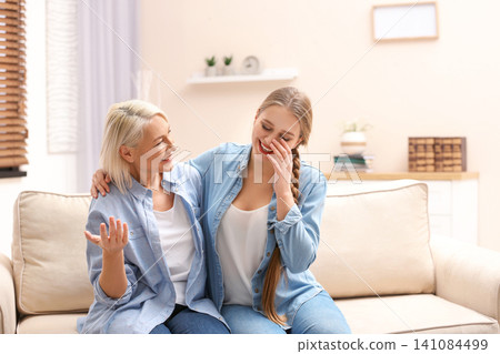 Mother and her adult daughter spending time together at home Mother and her adult daughter spending time together at home 141084499