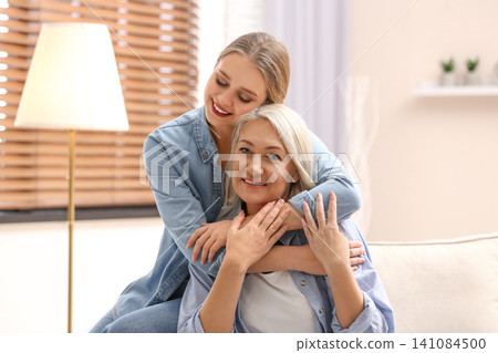 Mother and her adult daughter spending time together at home 141084500