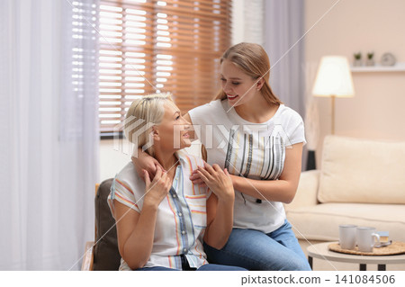Mother and her adult daughter spending time together at home 141084506