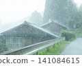 Heavy rain is beating down on an old farmhouse in the countryside. 141084615
